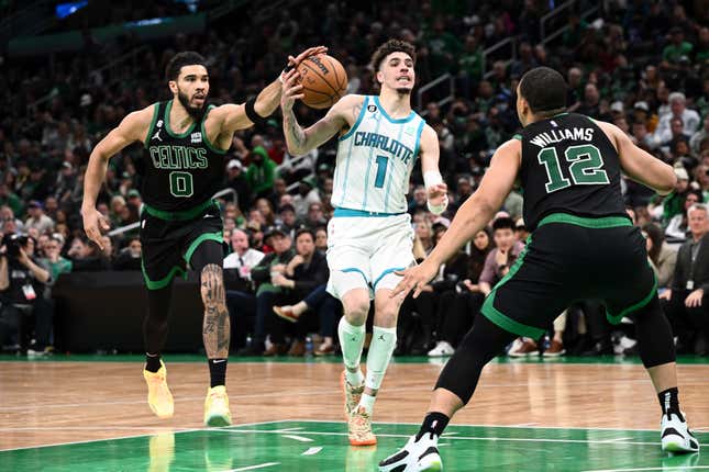 Jayson Tatum and Grant Williams of the Boston Celtics defend LaMelo Ball of the Charlotte Hornets during the fourth quarter of the game at the TD Garden on Feb. 10, 2023, in Boston.