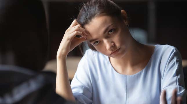bored, annoyed employee listening to co-worker