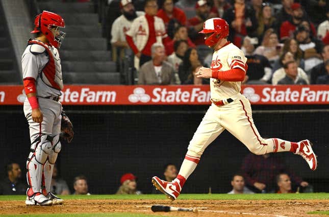 Apr 11, 2023; Anaheim, California, USA;  Washington Nationals catcher Keibert Ruiz (20) looks on as Los Angeles Angels left fielder Taylor Ward (3) crosses the plate to score a run on a sacrifice fly by third baseman Anthony Rendon (6) in the fourth inning at Angel Stadium.