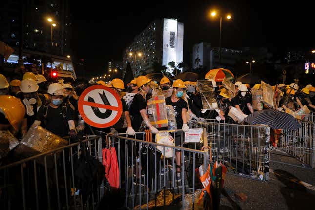 Protesters with protection gear hold homemade shields as they prepare to face off with police in Sha Tin in Hong Kong, July 14, 2019.