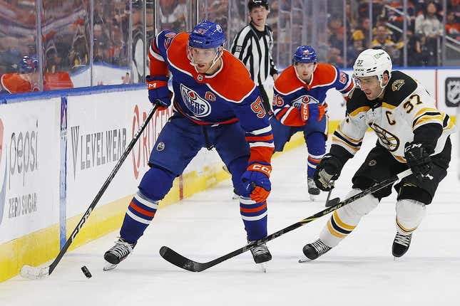 Feb 27, 2023; Edmonton, Alberta, CAN; Edmonton Oilers forward Connor McDavid (97) carries the puck around Boston Bruins forward Patrice Bergeron (37) during the third period at Rogers Place.