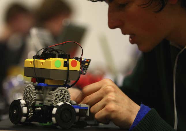 A students prepares his robot prior to taking part a Robocup soccer match.