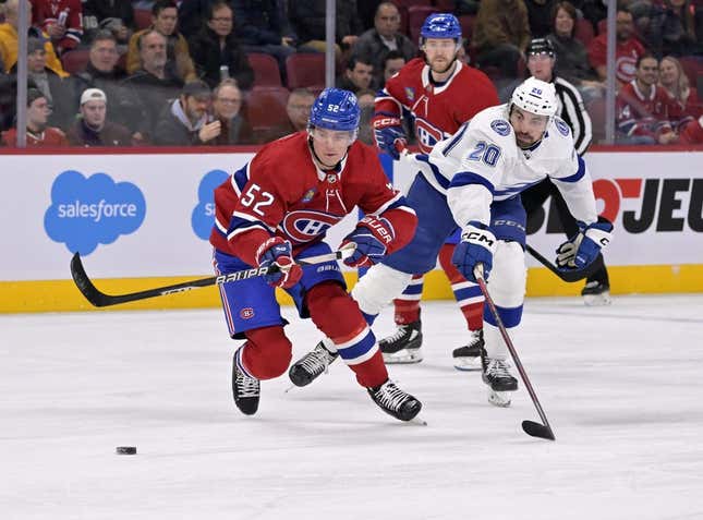 Mar 21, 2023; Montreal, Quebec, CAN; Montreal Canadiens defenseman Justin Barron (52) plays the puck as Tampa Bay Lightning forward Nicholas Paul (20) forechecks during the first period at the Bell Centre.