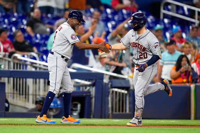 Aug 16, 2023; Miami, Florida, USA; Houston Astros center fielder Chas McCormick (20) celebrates with Houston Astros third base coach Gary Pettis (8) after hitting a home run against the Miami Marlins during the first inning at loanDepot Park.