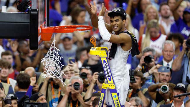 Remy Martin of Kansas cuts down the net after defeating the North Carolina Tar Heels during the second half of the 2022 NCAA Men’s Basketball Tournament National Championship.