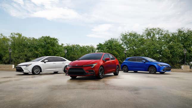 A photo of three new models of Toyota Corolla including two sedans and a hatchback. 