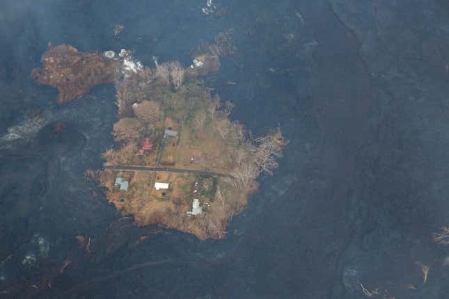 Image for article titled New aerial photos show Kilauea’s lava devouring neighborhoods