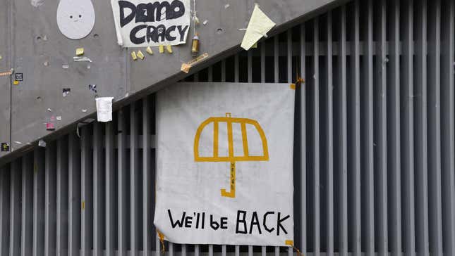 A poster of an umbrella with the words "We'll be back" written underneath is pictured on a wall at the main "Occupy" protest site at Admiralty in Hong Kong