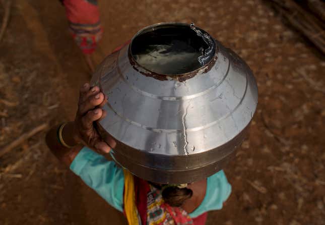 Bhaagi, third wife of Sakharam Bhagat, carries a metal pitcher filled with water