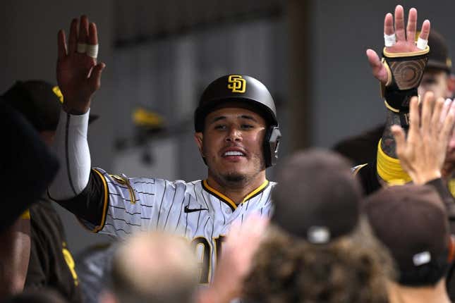Jun 13, 2023; San Diego, California, USA; San Diego Padres third baseman Manny Machado (right) is congratulated in the dugout after scoring a run against the Cleveland Guardians during the fifth inning at Petco Park.