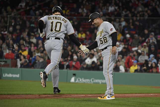 Apr 4, 2023; Boston, Massachusetts, USA;  Pittsburgh Pirates center fielder Bryan Reynolds (10) is congratulated by third base coach Mike Rabelo (58) after hitting a home run during the third inning against the Boston Red Sox at Fenway Park.
