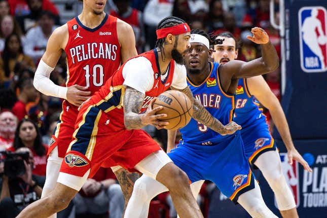 Apr 12, 2023; New Orleans, Louisiana, USA; New Orleans Pelicans forward Brandon Ingram (14) dribbles against Oklahoma City Thunder guard Luguentz Dort (5) during the first half at Smoothie King Center.