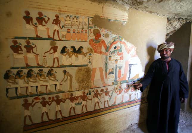 epa06378798 A local Egyptian guard pose at a recently found tomb and re-discovery of an older one, at Draa Abul Naga necropolis on Luxor?s west bank, 700km south of Cairo, Egypt, 09 December 2017. Egypt's Ministry of Antiquities announced the discovery of a tomb from the New Kingdom that belongs to the old Egyptian deity Amun's Goldsmith, Amenemhat (tomb number Kampp 390) and a burial shaft housing the mummy of a lady and her two children. The newly discovered tomb includes an entrance located in the courtyard of another Middle Kingdom tomb number Kampp 150. EPA-EFE/KHALED ELFIQI