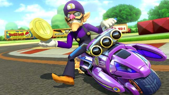A screenshot of Mario Kart shows Waluigi holding a gold coin while riding a motorcycle. 