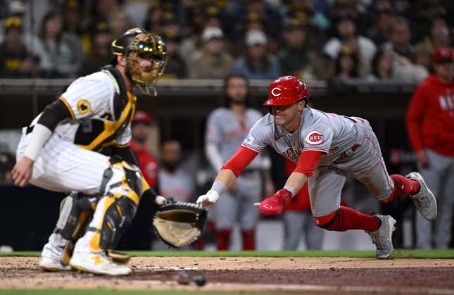 May 2, 2023; San Diego, California, USA; Cincinnati Reds center fielder TJ Friedl (right) scores a run ahead of the throw to San Diego Padres catcher Austin Nola (left) during the eighth inning at Petco Park.