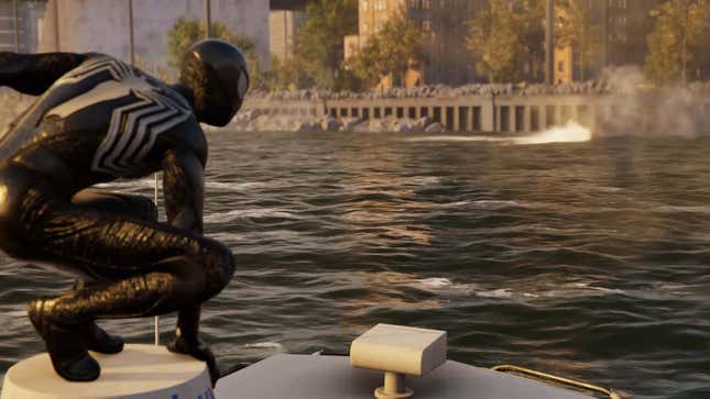 Spider-Man in his black suit looks at a large body of water. 
