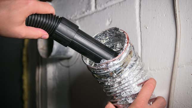 A vacuum cleaner attachment is inserted into a flexible dryer vent hose
