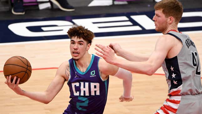 LaMelo Ball of the Charlotte Hornets looks to shoot in front of Davis Bertans of the Washington Wizards during the second half at Capital One Arena on May 16, 2021 in Washington, DC.