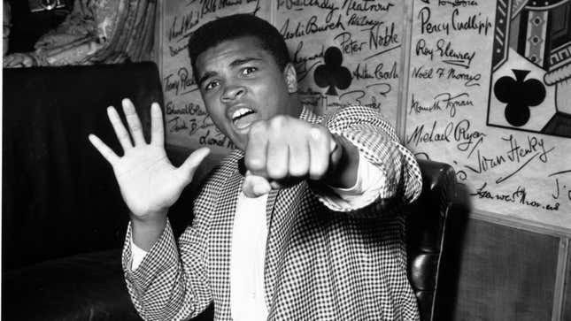 Cassius Clay holds up five fingers in a prediction of how many rounds it will take him to knock out British boxer Henry Cooper on May 27, 1963.