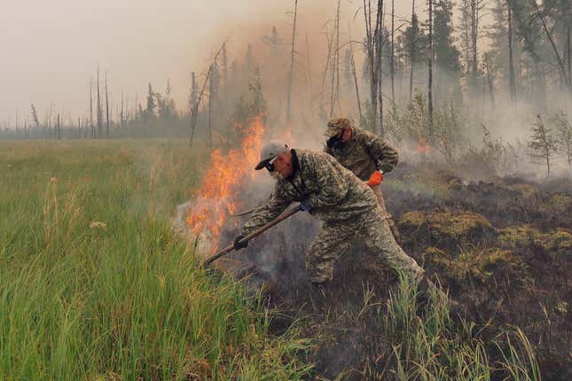 Volunteers douse a forest fire in the republic of Sakha also known as Yakutia, Russia Far East, Saturday, July 17, 2021.