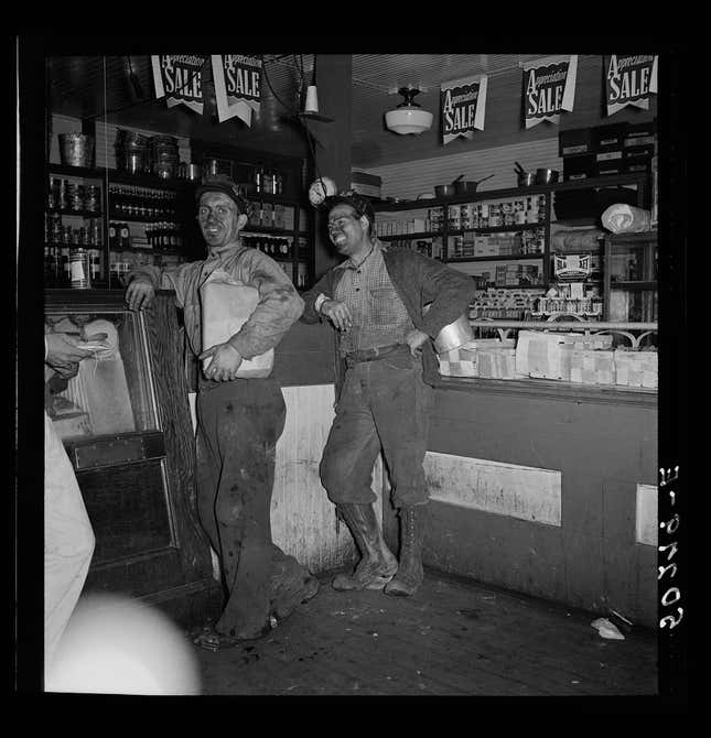 Coal miners buying groceries in a company store in West Virginia in 1938. Library of Congress/Marion Post Wolcott.