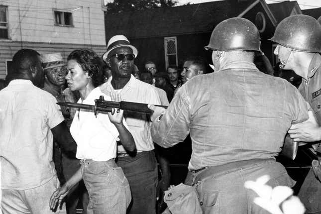In this July 21, 1963, file photo, Gloria Richardson, head of the Cambridge Nonviolent Action Committee, pushes a National Guardsman’s bayonet aside as she moves among a crowd of African Americans to convince them to disperse in Cambridge, Md. 