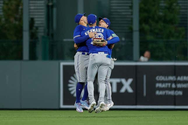 Sep 1, 2023; Denver, Colorado, USA; Toronto Blue Jays center fielder Kevin Kiermaier (39) and right fielder George Springer (4) and left fielder Daulton Varsho (25) celebrate after the game against the Colorado Rockies at Coors Field.