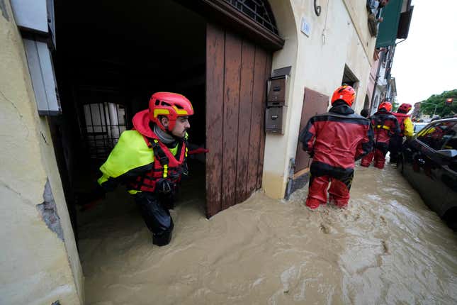 Photo of rescuers exiting flooded building