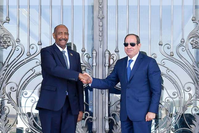 In this photo provided by Egypt&#39;s presidency media office, Egyptian President Abdel-Fattah el-Sissi, right, greets Sudan&#39;s army chief General Abdel Fattah al-Burhan at the Presidential palace in el-Alamein city, Egypt, Tuesday, Aug. 29, 2023. (Egyptian Presidency Media Office via AP)