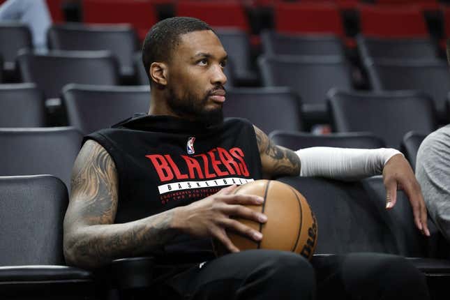 Mar 27, 2023; Portland, Oregon, USA; Portland Trail Blazers point guard Damian Lillard (0) watches players warm up prior to the game against the New Orleans Pelicans at Moda Center.