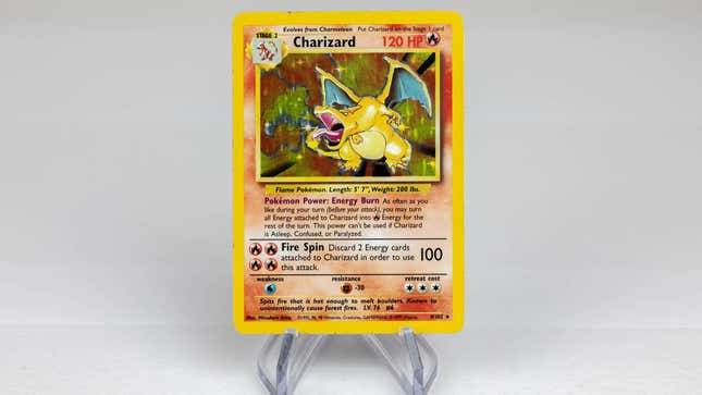 an original holographic charizard card set against an off white background