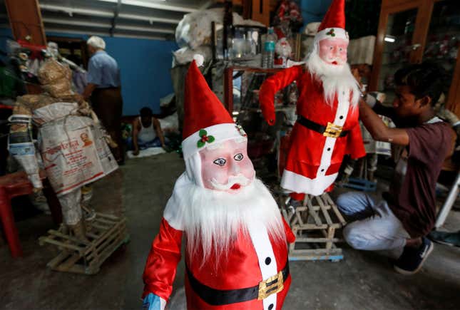 Photos of Christmas preparations, Santa Claus masks in India