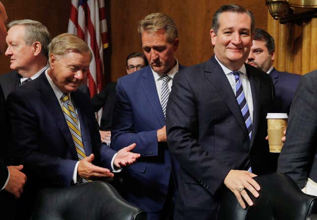 Lindsey Graham talks to Jeff Flake about his vote as they depart with Ted Cruz after the judiciary committee voted to move the nomination of Brett Kavanaugh forward to the full Senate.