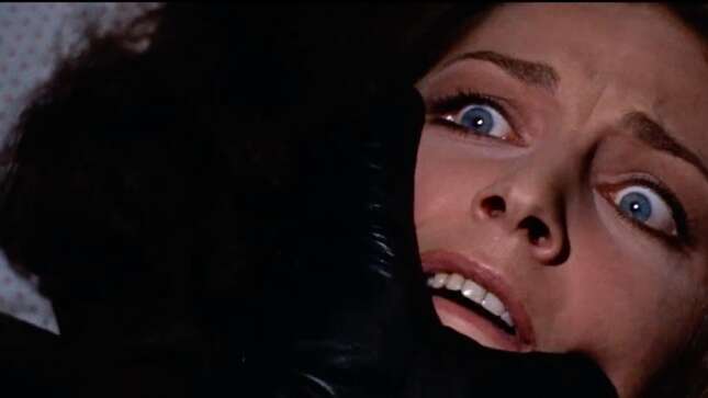 A black-gloved hand moves to cover a terrified woman's face in a scene from 1970's The Bird With the Crystal Plumage.