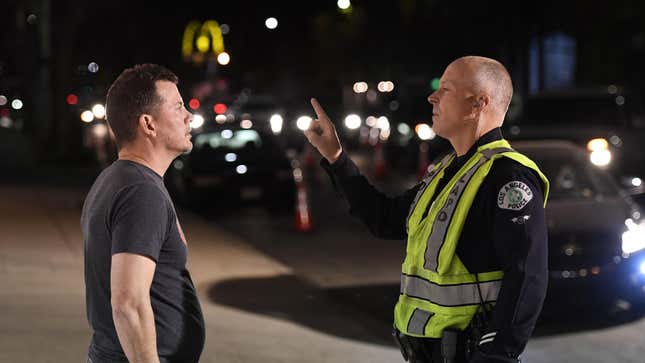 A man undergoes a sobriety test at a LAPD police DUI checkpoint in Reseda, Los Angeles, California on April 13, 2018