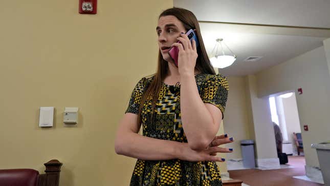 State Rep. Zooey Zephyr (D) on the phone after House Speaker Matt Regier (R) told her she could not work from the hallway outside the main chamber of the Montana House of Representatives on Thursday.