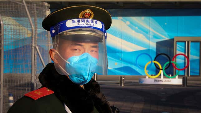 A paramilitary Police officer stands guard in front the Olympic Rings in a closed loop area near venues of the Beijing 2022 Winter Olympics.