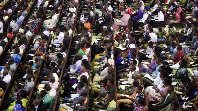 Worshippers listen to a sermon at the Living Faith Church, also known as the Winners' Chapel, in Ota district, Ogun state, some 60 km (37 miles) outside Nigeria's commercial capital Lagos September 28, 2014. Hundreds of millions of dollars change hands each year in Nigeria's popular Pentecostal "megachurches", which are modelled on their counterparts in the United States. Some of these churches can hold more than 200,000 worshippers and, with their attendant business empires, they constitute a significant section of the economy, employing tens of thousands of people and raking in tourist dollars, as well as exporting Christianity globally.