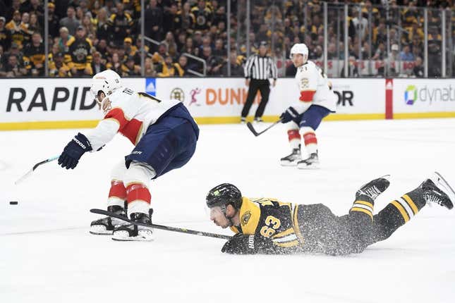 Apr 30, 2023; Boston, Massachusetts, USA; Boston Bruins left wing Brad Marchand (63) gets tripped up while Florida Panthers left wing Matthew Tkachuk (19) skates after the loose puck during the first period in game seven of the first round of the 2023 Stanley Cup Playoffs at TD Garden.