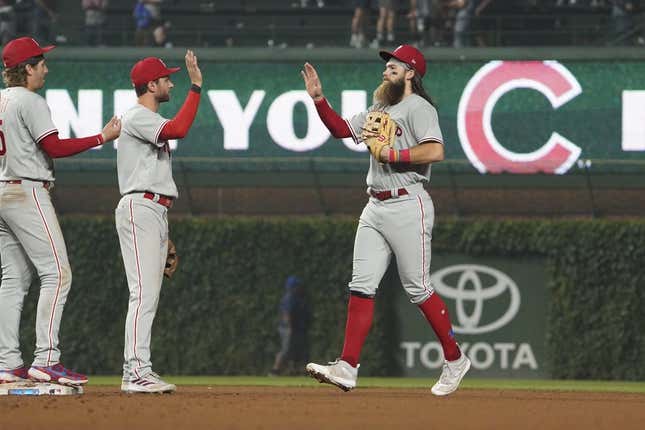 Jun 27, 2023; Chicago, Illinois, USA; Philadelphia Phillies center fielder Brandon Marsh (right) and shortstop Trea Turner (center) react after defeating the Chicago Cubs at Wrigley Field.