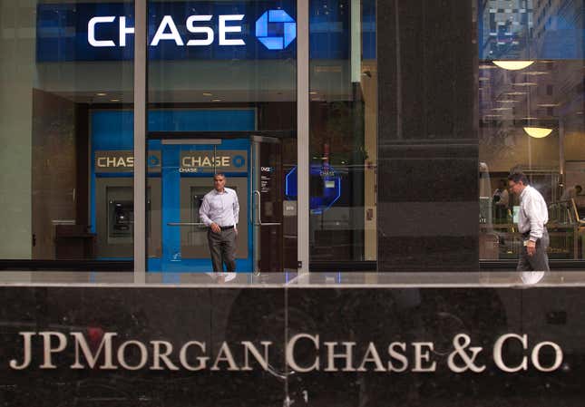 FILE PHOTO: A customer exits the lobby of JPMorgan Chase & Co. headquarters in New York May 14, 2012.REUTERS/Eduardo Munoz/File Photo