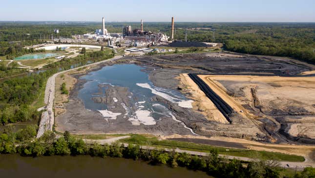 The Richmond, Va., city skyline is seen in the horizon behind the coal ash ponds along the James River near Dominion Energy’s Chesterfield Power Station in Chester, Va. 