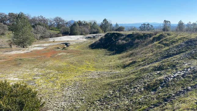 On the edge of the Tailings 4 Area of the Argonaut Mine Superfund Site, there’s an old earthen dam that was constructed out of the leftover waste and rocks dug up from the mine, to stop mine waste from flowing off the site. The dam used to be about 20 feet taller, but in the 1970s, the city dug some of it out to build roads around town. 