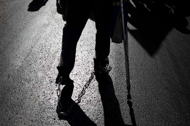 A protester walks in chains
