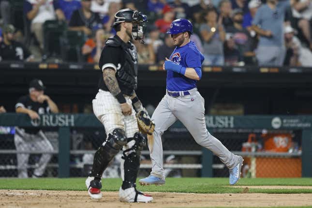 Jul 25, 2023; Chicago, Illinois, USA; Chicago Cubs left fielder Ian Happ (8) scores against the Chicago White Sox during the seventh inning at Guaranteed Rate Field.