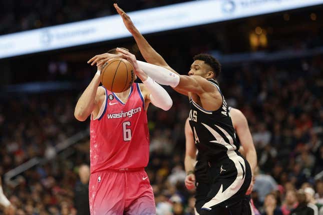 Mar 5, 2023; Washington, District of Columbia, USA; Milwaukee Bucks forward Giannis Antetokounmpo (34) knocks the ball from Washington Wizards center Kristaps Porzingis (6) in the second quarter at Capital One Arena.