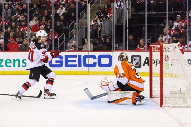 Feb 25, 2023; Newark, New Jersey, USA; New Jersey Devils center Dawson Mercer (91) scores a goal on Philadelphia Flyers goaltender Samuel Ersson (33) during the second period at Prudential Center.