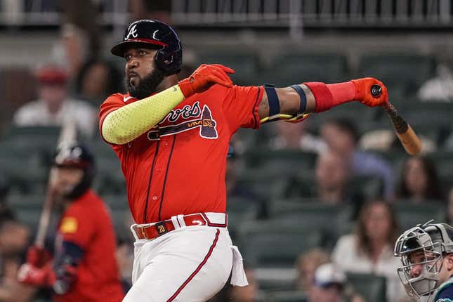 May 19, 2023; Cumberland, Georgia, USA; Atlanta Braves designated hitter Marcell Ozuna (20) singles driving in two runs against the Seattle Mariners during the eighth inning at Truist Park.