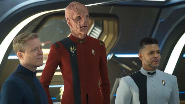 Stamets (Anthony Rapp), Saru (Doug Jones), and Culber (Wilson Cruz) wearing their Starfleet uniforms in a scene from Star Trek: Discovery.