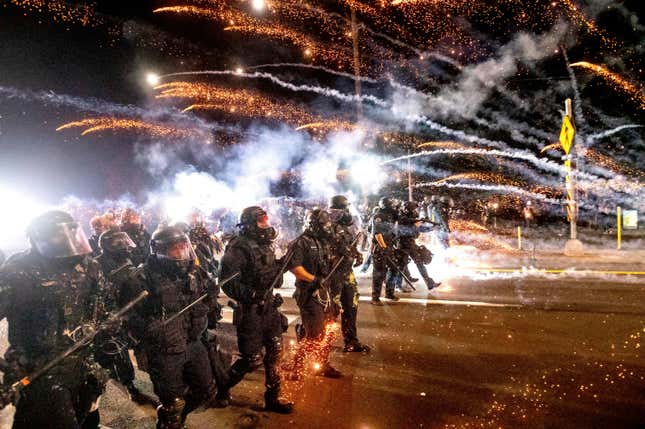 Police use chemical irritants and crowd control munitions to disperse protesters during a demonstration against police violence and racial injustice in Portland, Ore., Saturday, Sept. 5, 2020, sparked by the killing of George Floyd.